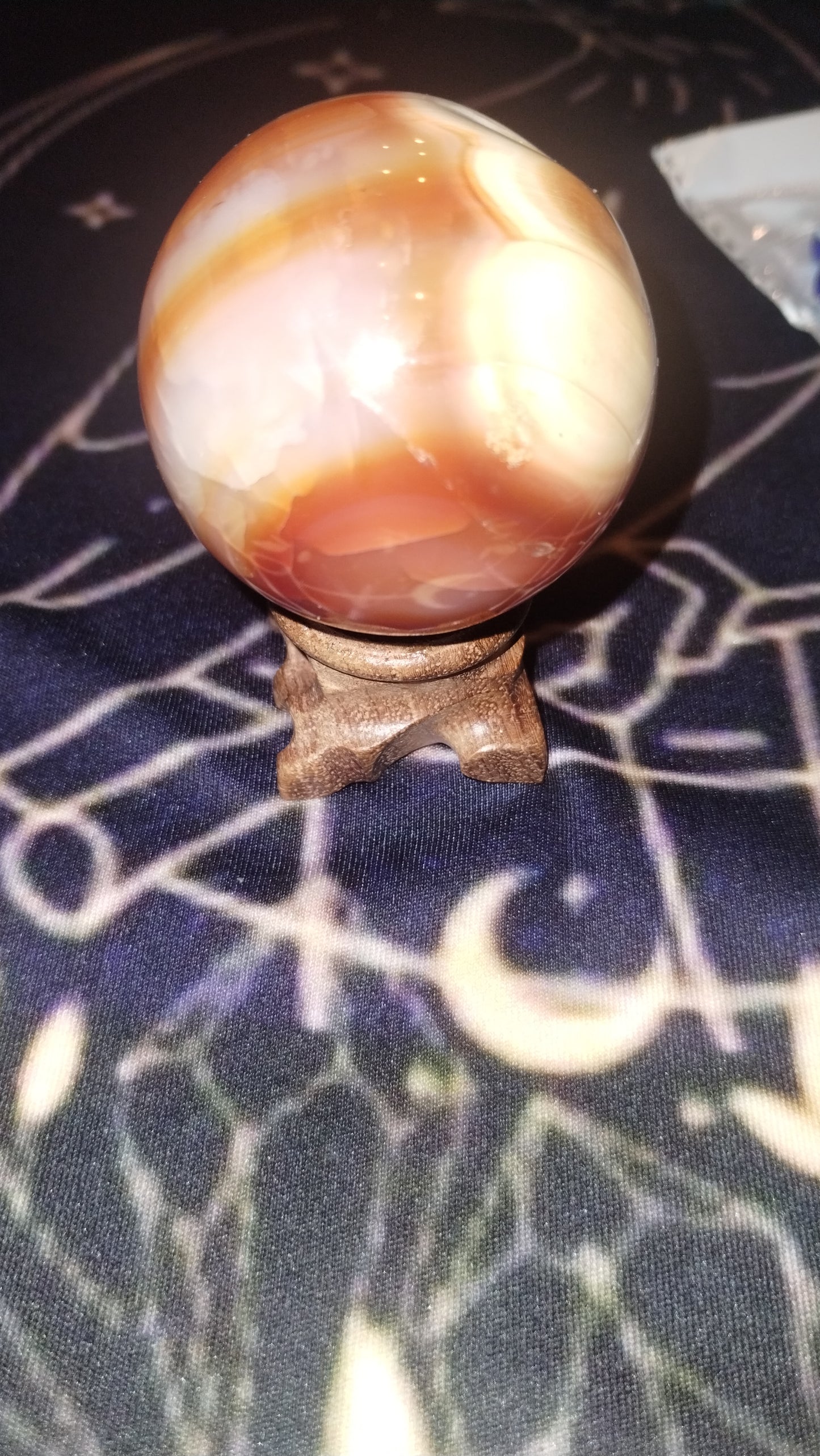 Carnelian sphere and wooden stand
