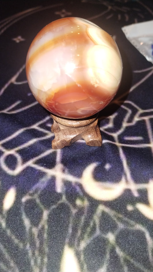 Carnelian sphere and wooden stand
